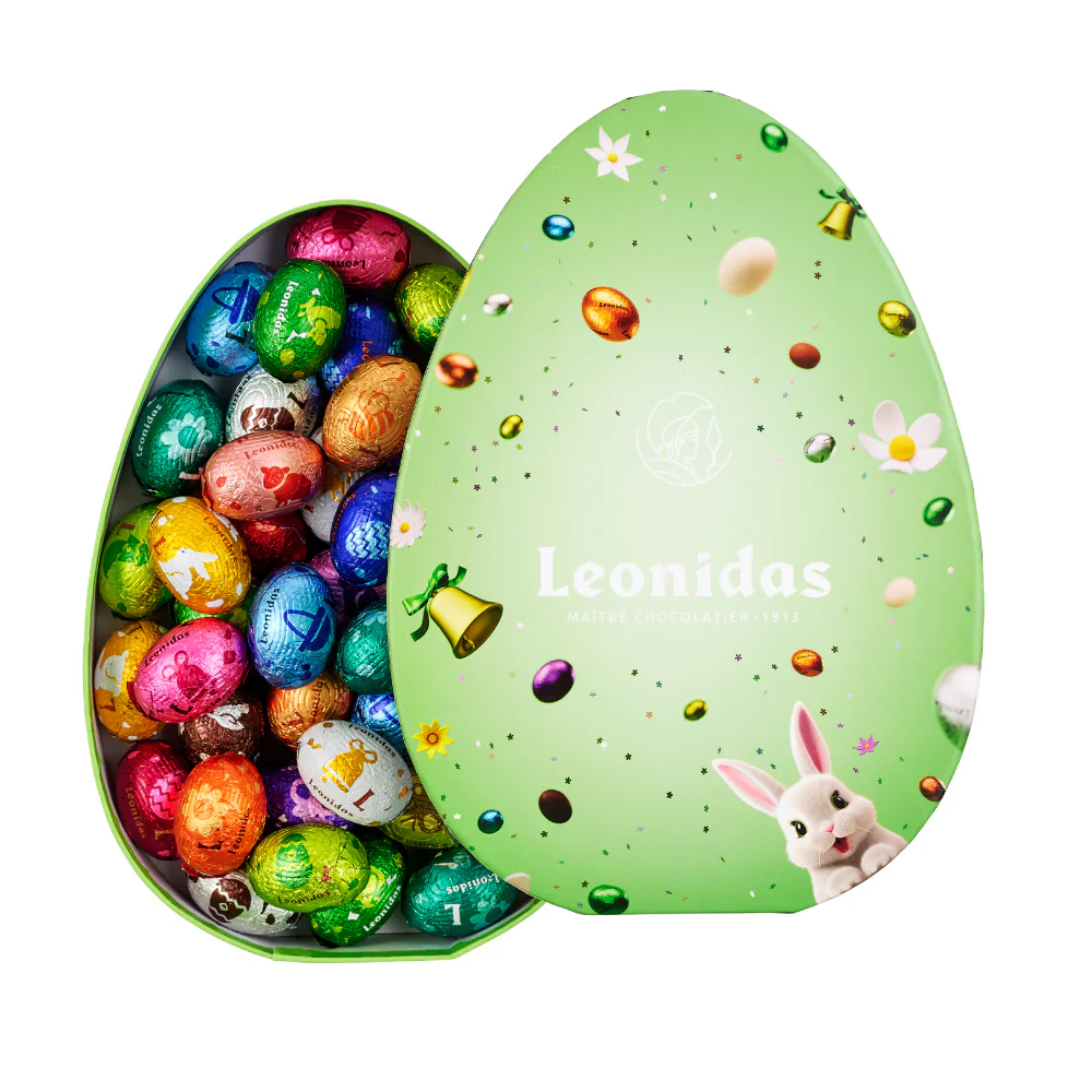 A green oval box from Leonidas full of colourful mini-eggs.