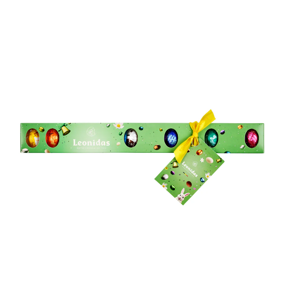 A green Leonidas tube filled with colourful mini-eggs.