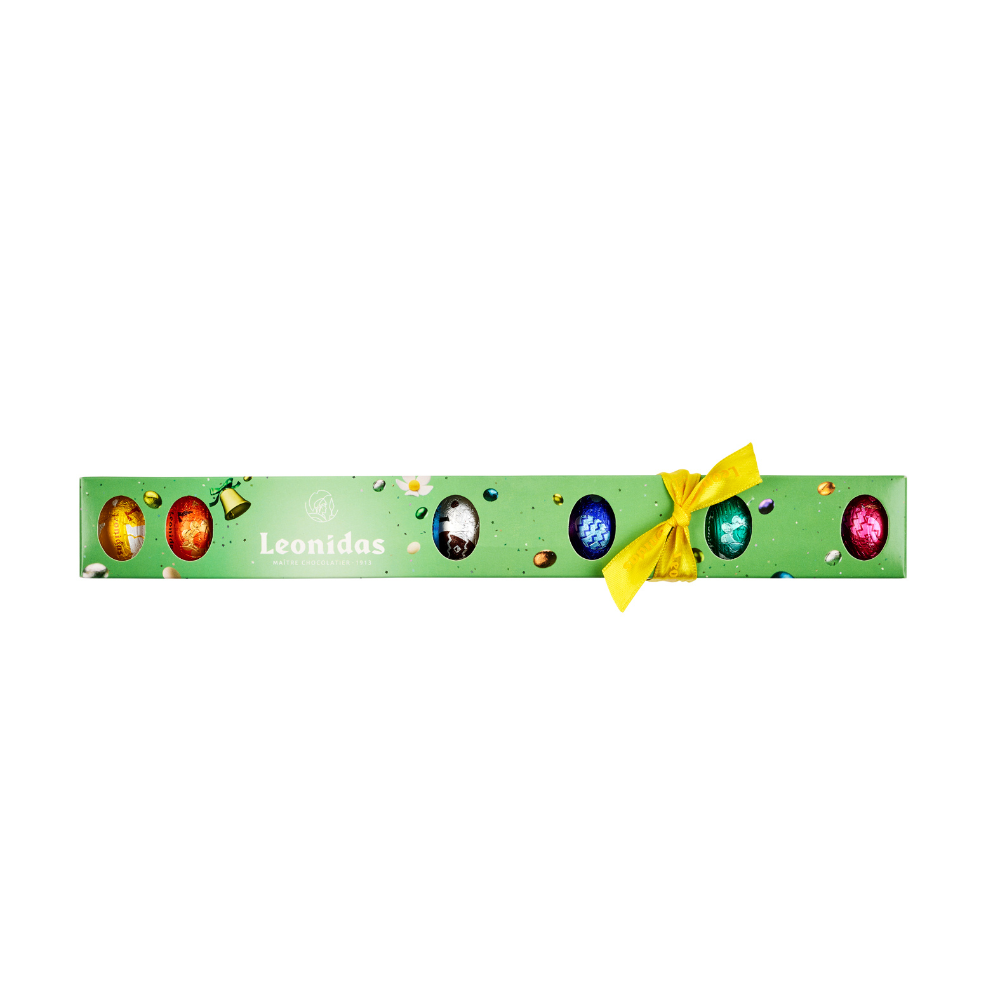 A green Leonidas tube filled with colourful mini-eggs and finished with a yellow Leonidas ribbon.