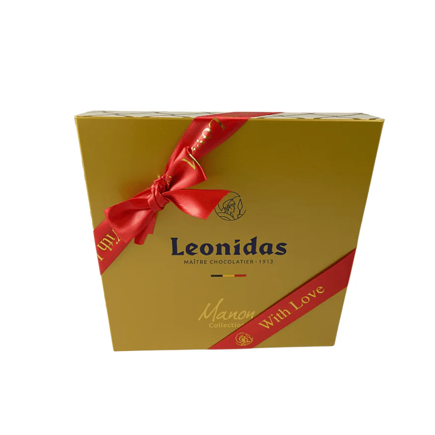 A gold Leonidas gift box with a red with love ribbon