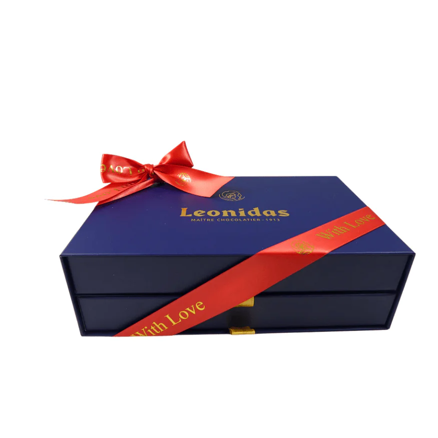 A Blue Leonidas gift box wrapped with a red with Love ribbon.