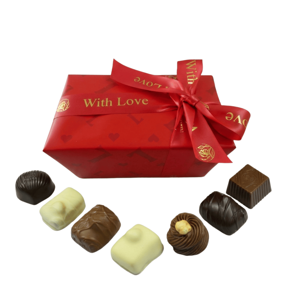 A box of chocolate wrapped in red Valentine's wrapping paper and with a red "would love" ribbon with chocolate arranged around it.