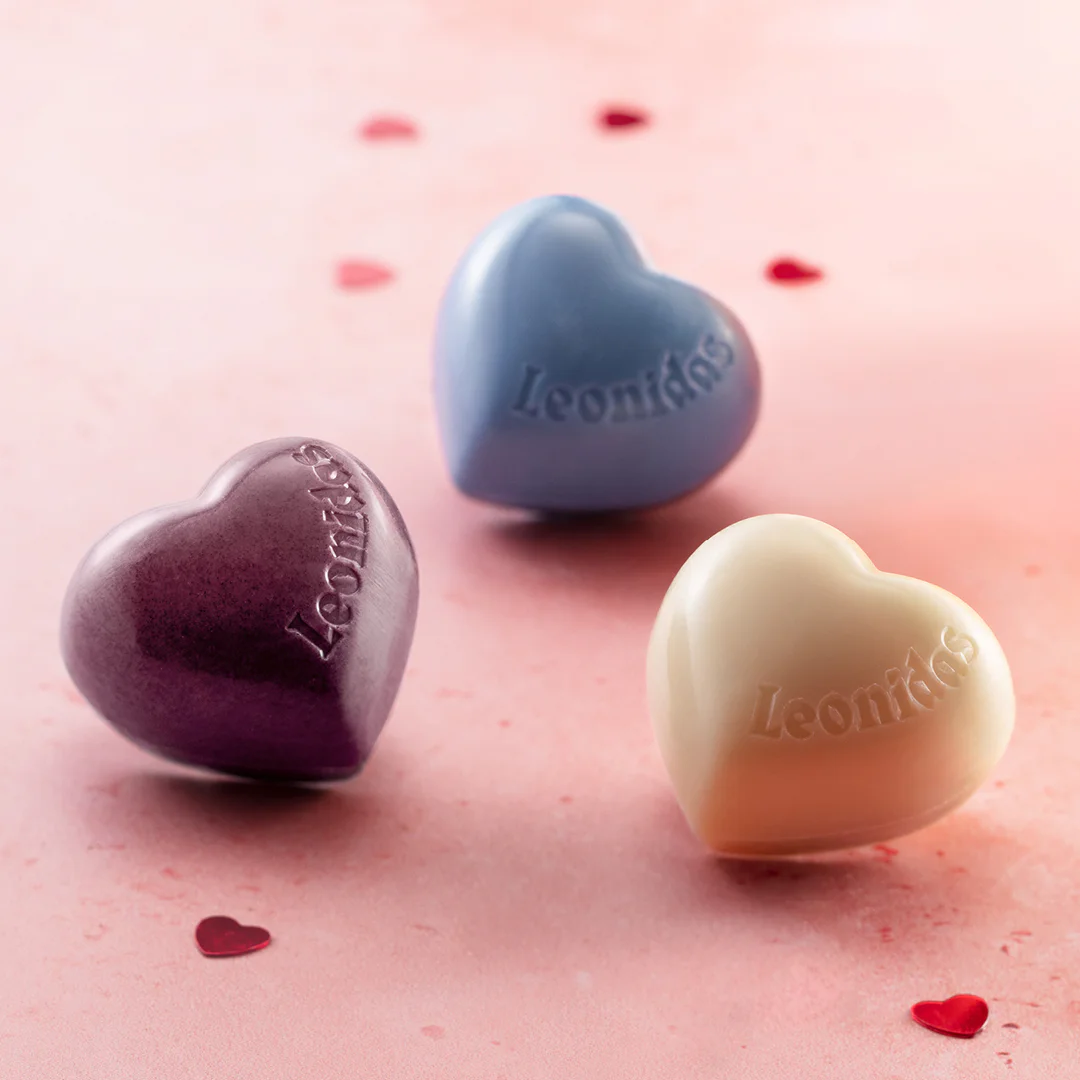 A close-up shot of three Leonidas chocolate hearts