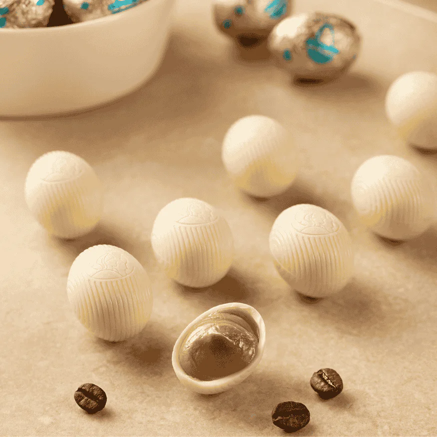 a close up of wrapped and unwrapped leonidas white chocolate mini eggs