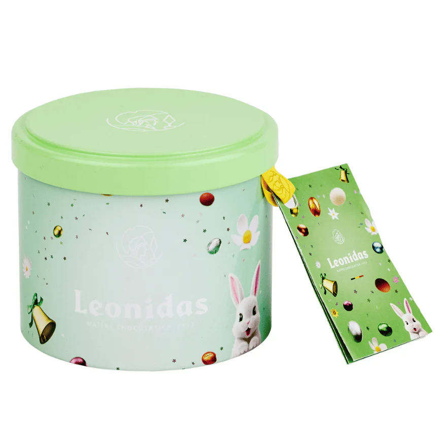 a small green leonidas easter cylinder withit lid on filled with eggs