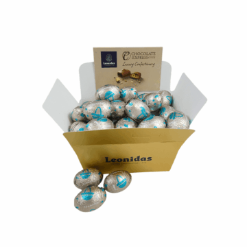 A gold box full of white Leonidas manon mini eggs.