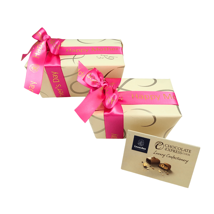 A side view Two boxes of Leonidas chocolates in champagne-coloured paper, and both with Mother's Day ribbon. One box is bigger than the other.