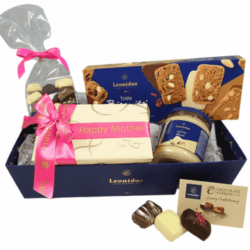 a blue hamper filled with chocolates and a pink leonidas tin heart wrapped in a mothers day ribbon