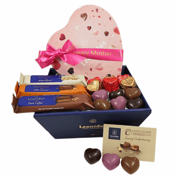 a blue hamper filled with chocolates and a pink leonidas tin heart wrapped in a mothers day ribbon