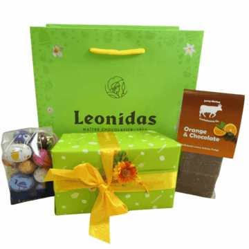 easter leonidas green bag with a bag of mini eggs, chocolate express orange and chocolate fudge bag and a classic box of leonidas chocolates wrapped in easter green wrapping paper