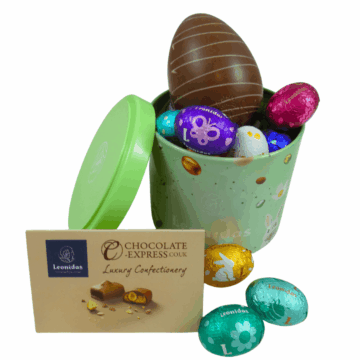 small green cylinder filled with foil wrapped leonidas mini eggs and a larger milk chocolate hollow egg