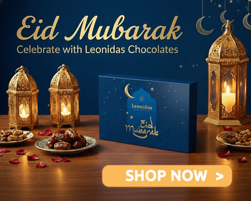 A blue leonidas box decorated for Eid Mubarak on a table with tea lamps and dates