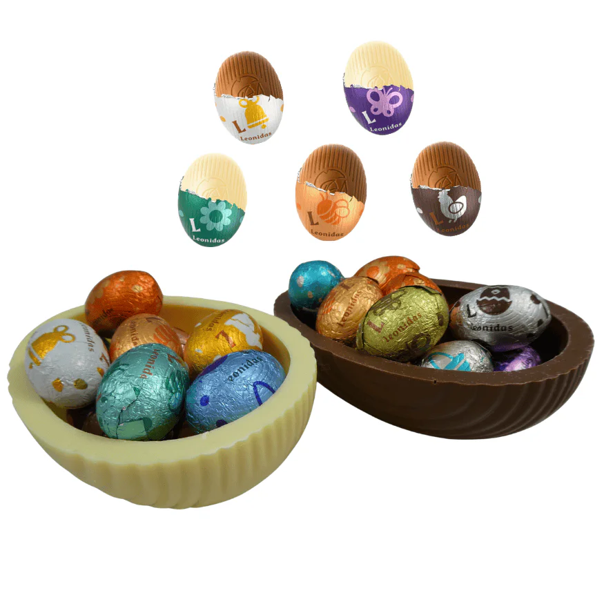 a milk and a white egg shell both filled with colourful leonidas mini eggs