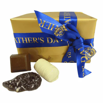 gold box of leonidas chocolates wrapped with a fathers day ribbon