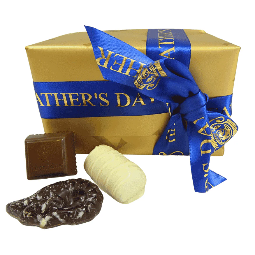 gold box of leonidas chocolates wrapped with a fathers day ribbon