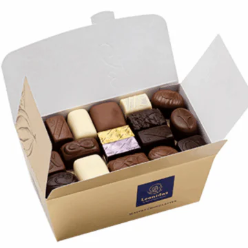 large open gold box full of chocolates