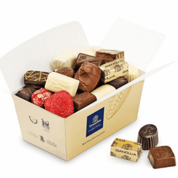 large open gold box full of leonidas chocolates