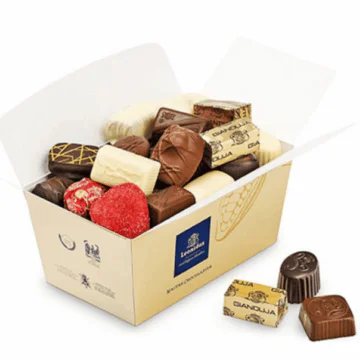 large open gold box full of leonidas chocolates