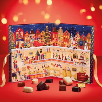 leonidas advent calendar on red background with chocolates in front